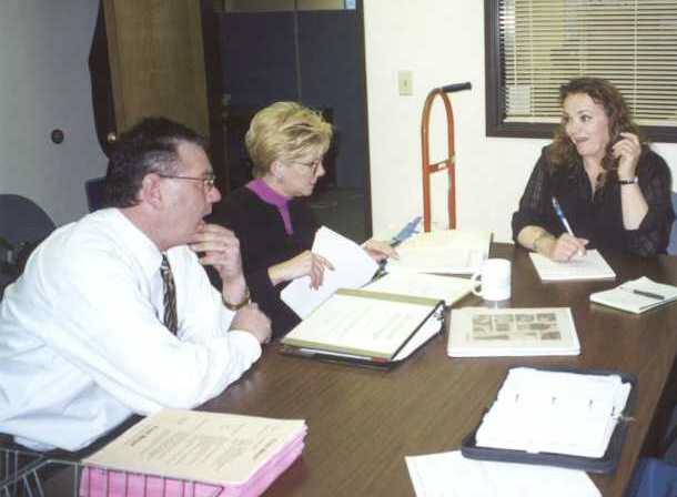 Left to right: Michael Vincent, Fred Meyer Store Director, Mary Lucas, Seattle Fred Meyer Human Resources Supervisor, and Nancy Heckmann, State Employment Security Sepcialist review hiring plan for new Fred Meyer store.